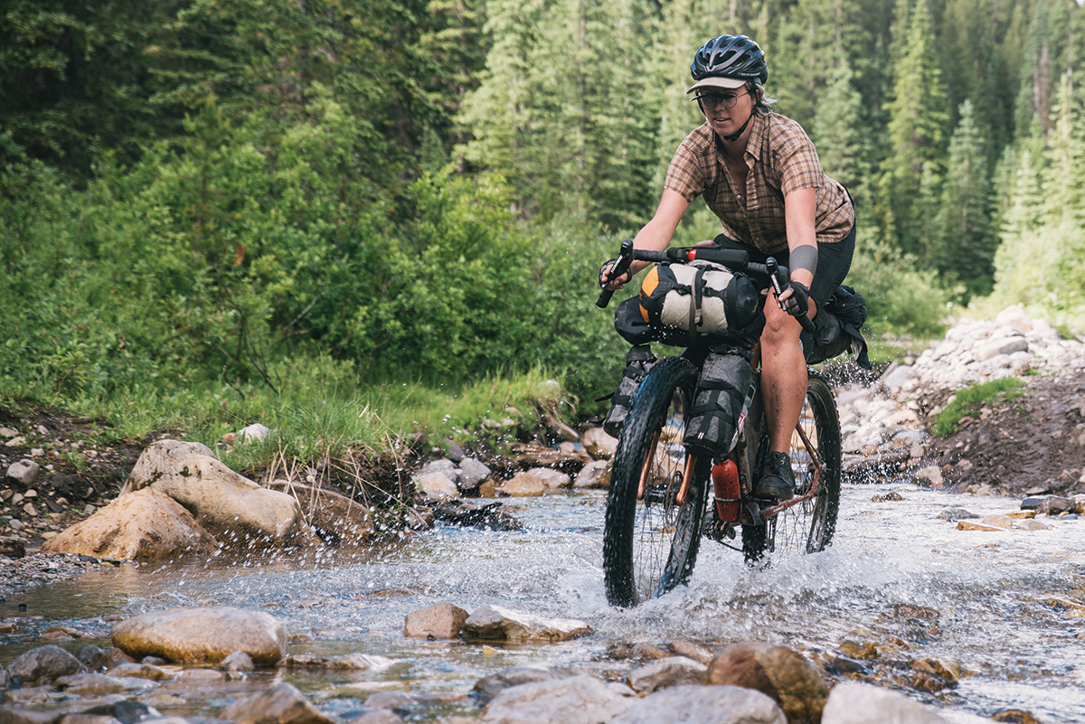 The author navigates a stream along the Great Divide mountain bike route