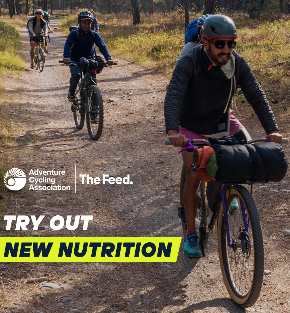 Men riding with loaded bikes. Text Try out new nutrition.
