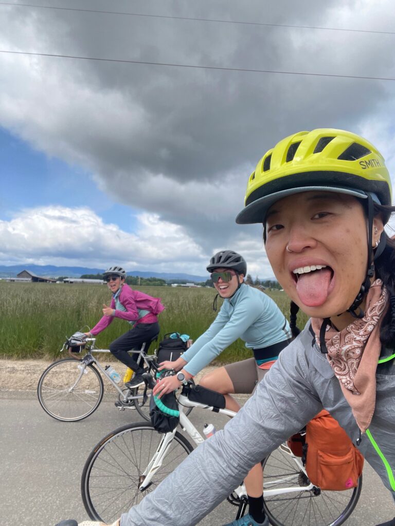 Three people riding with one sticking their tongue out.