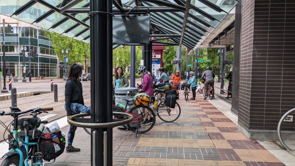 Riders wait at a station for MAX, a Portland-area light rail.